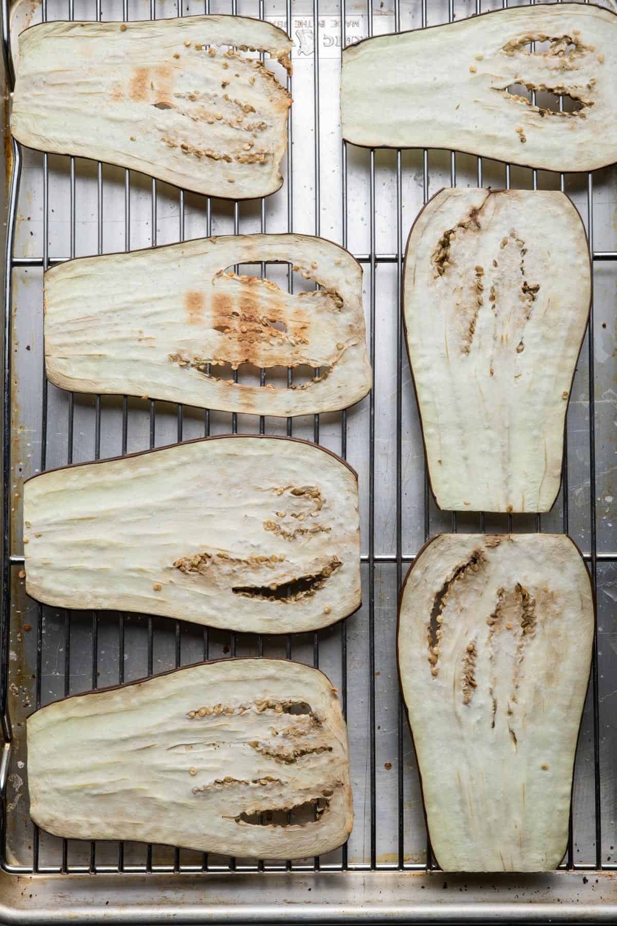 Eggplant on wire rack showing beads of sweat from salting.