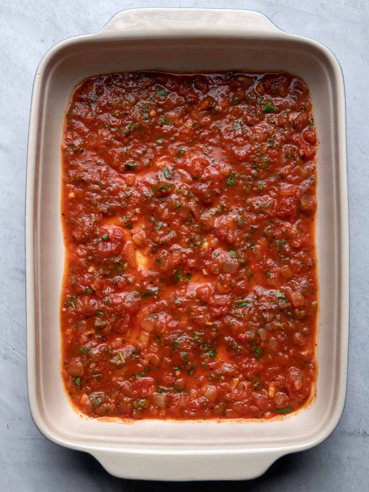 Tomato sauce in bottom of pan.