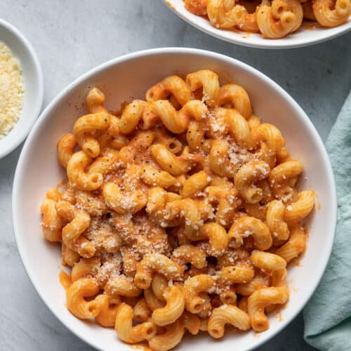 2 bowls of the pumpkin pasta served with side of grated parmesan cheese