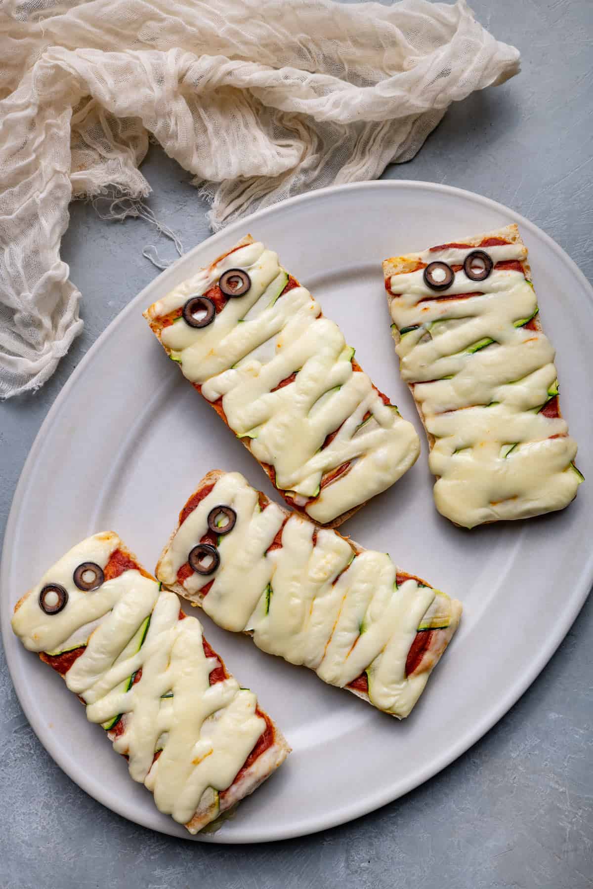 Mummy pizzas on a platter