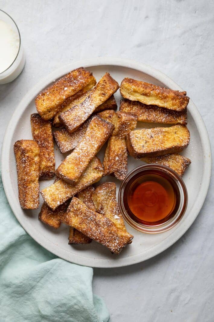 Air fryer french toast served with bowl of maple syrup