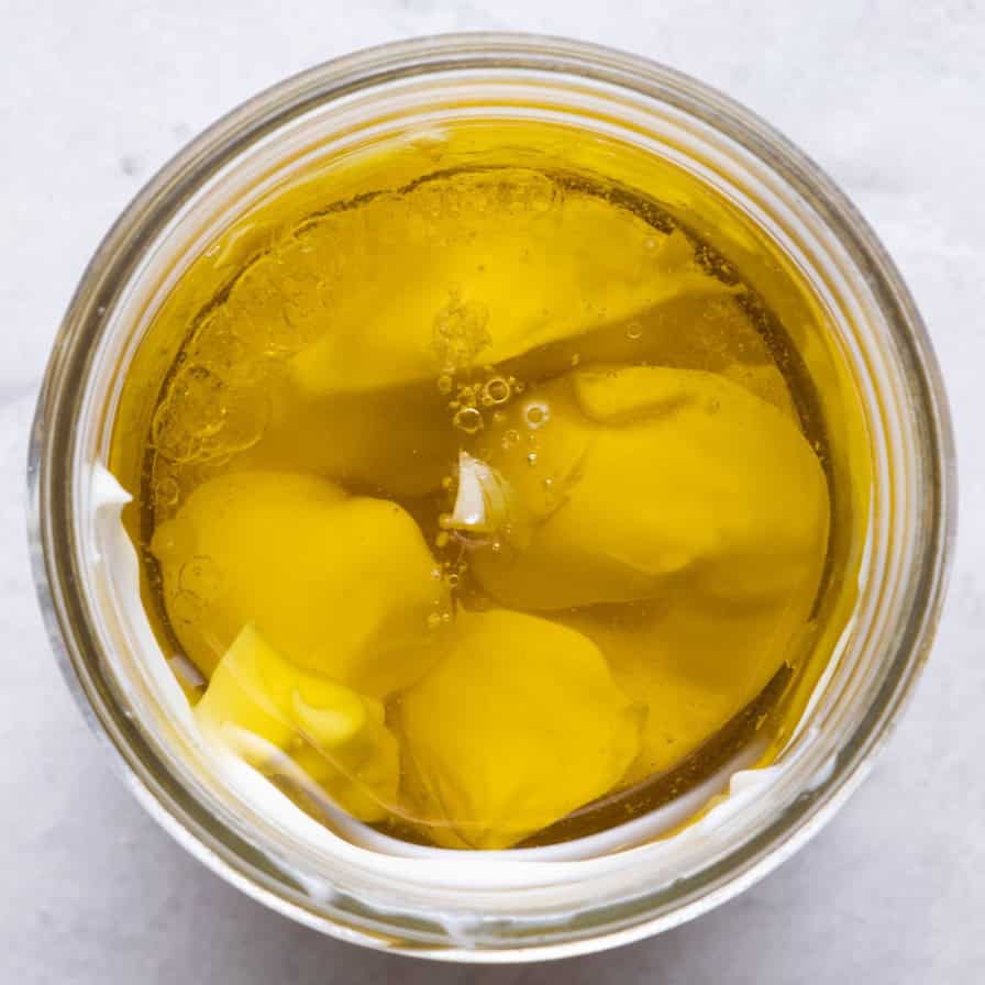 Dressing ingredients in mason jar before mixing.