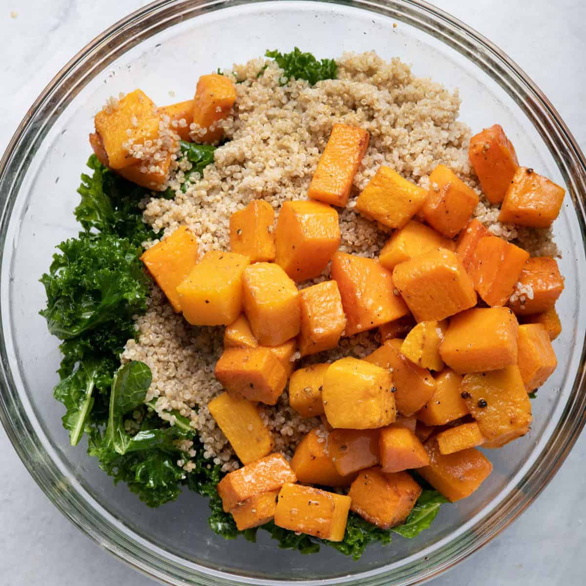 Quinoa and butternut squash on top of massaged kale.