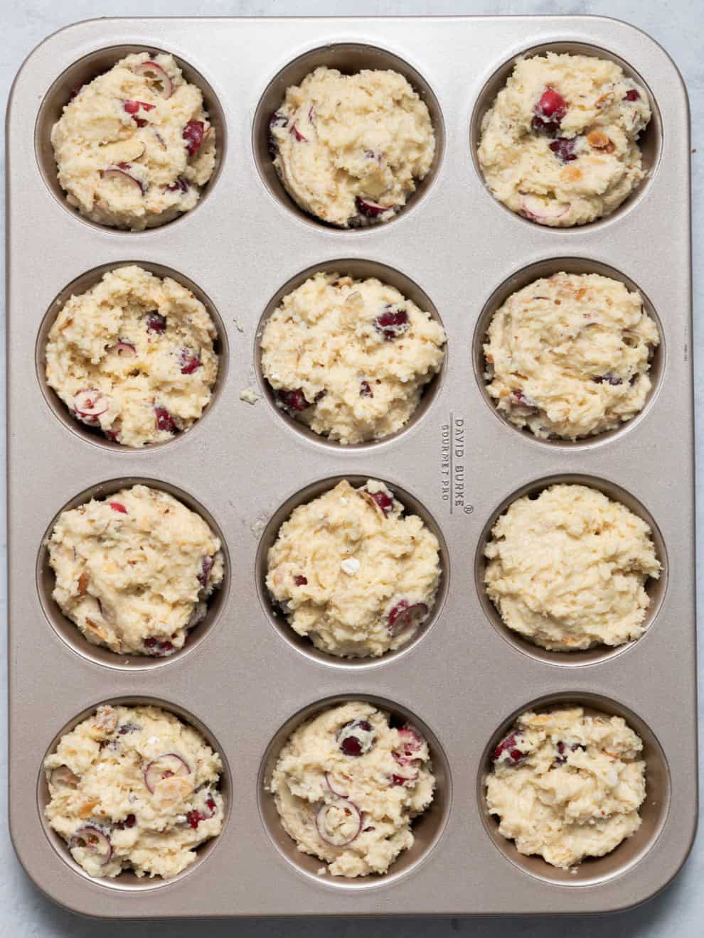 Muffin batter in muffin tin before baking.