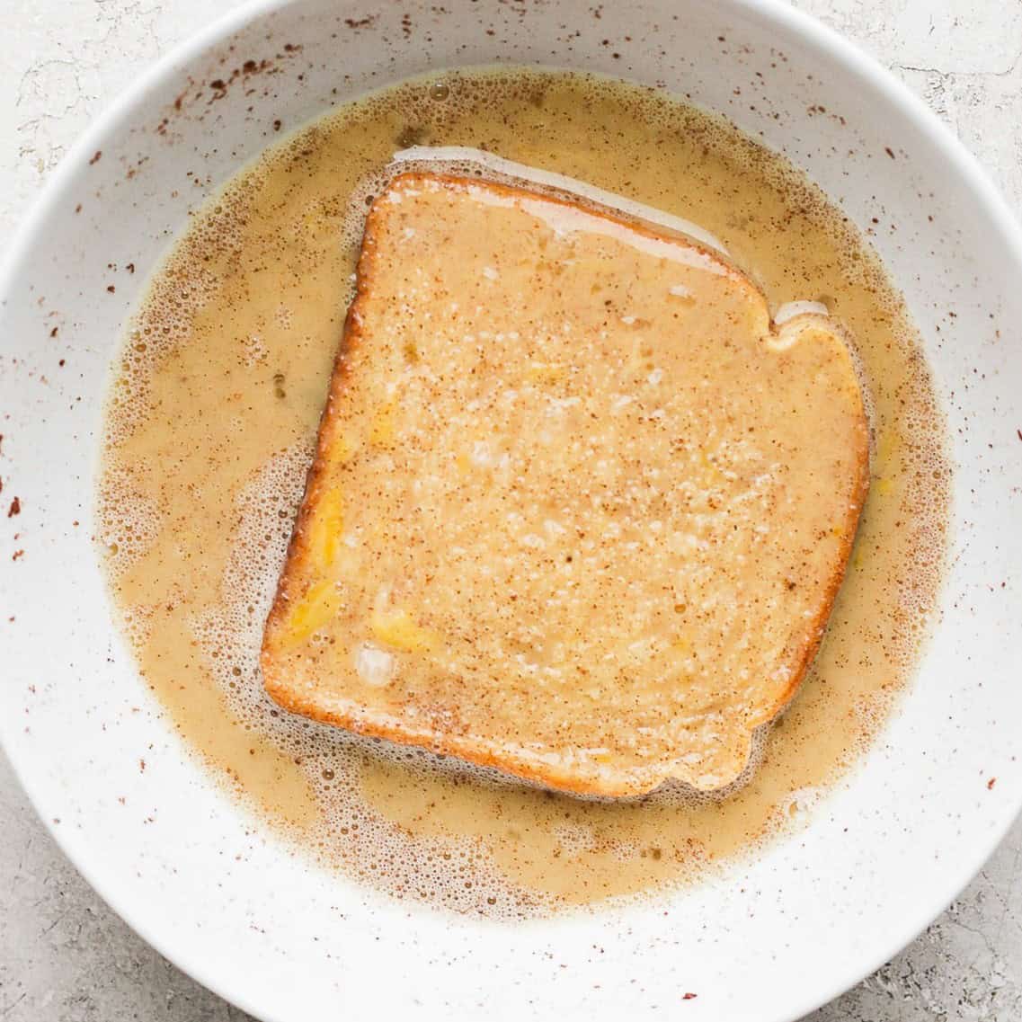 A piece of bread flipped in the bowl.