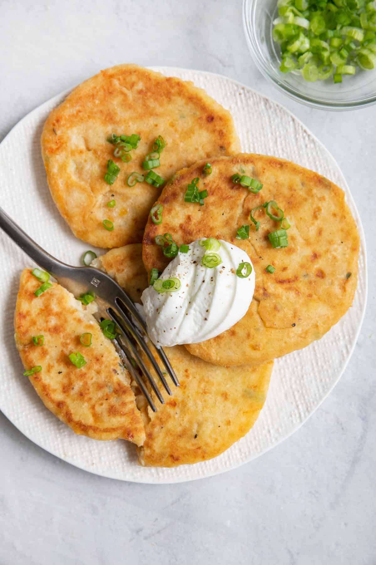 Fork cutting into mashed potato pancakes