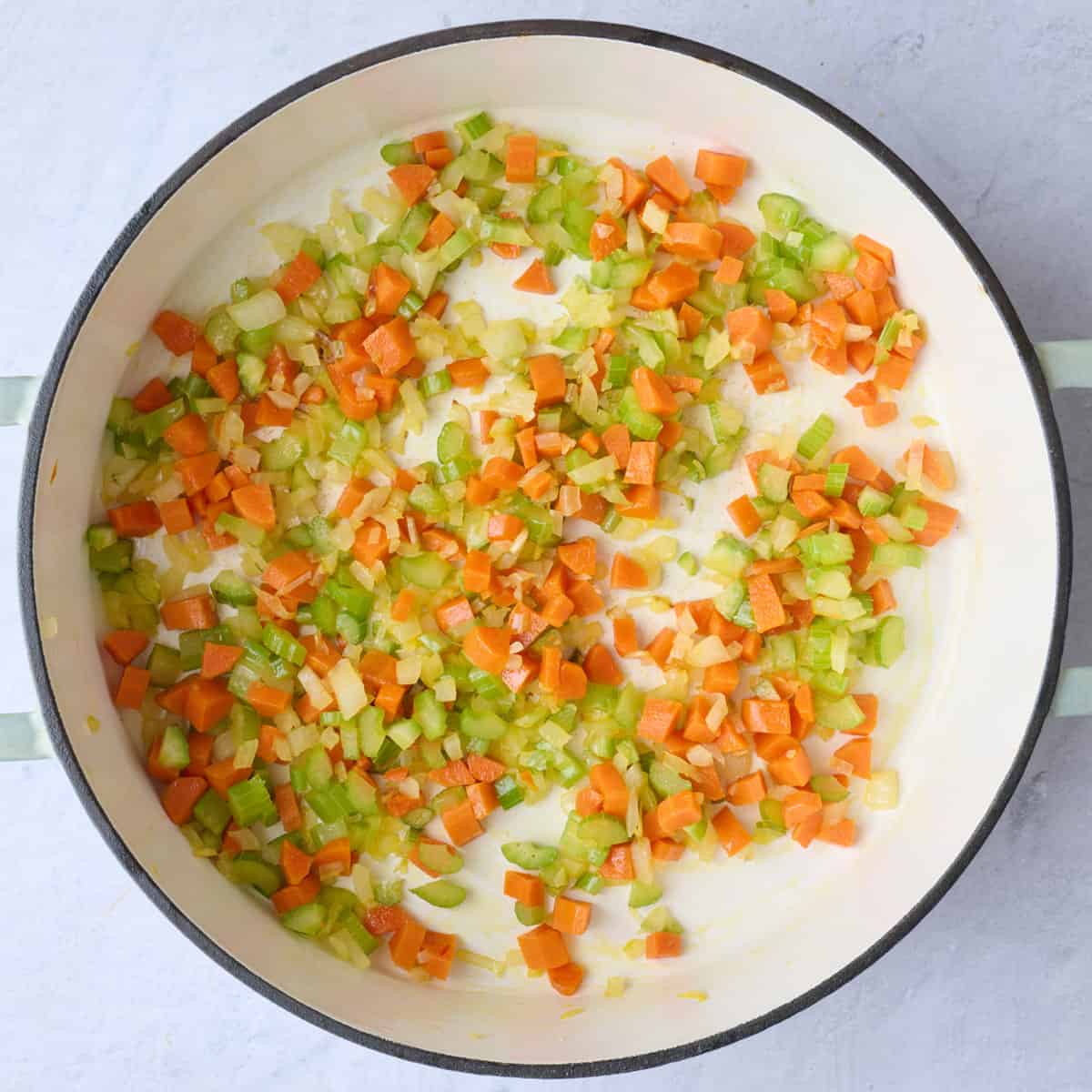 Onion, carrots and celery in a pot after cooking.