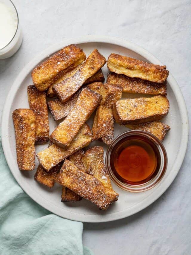 Air fryer french toast served with bowl of maple syrup