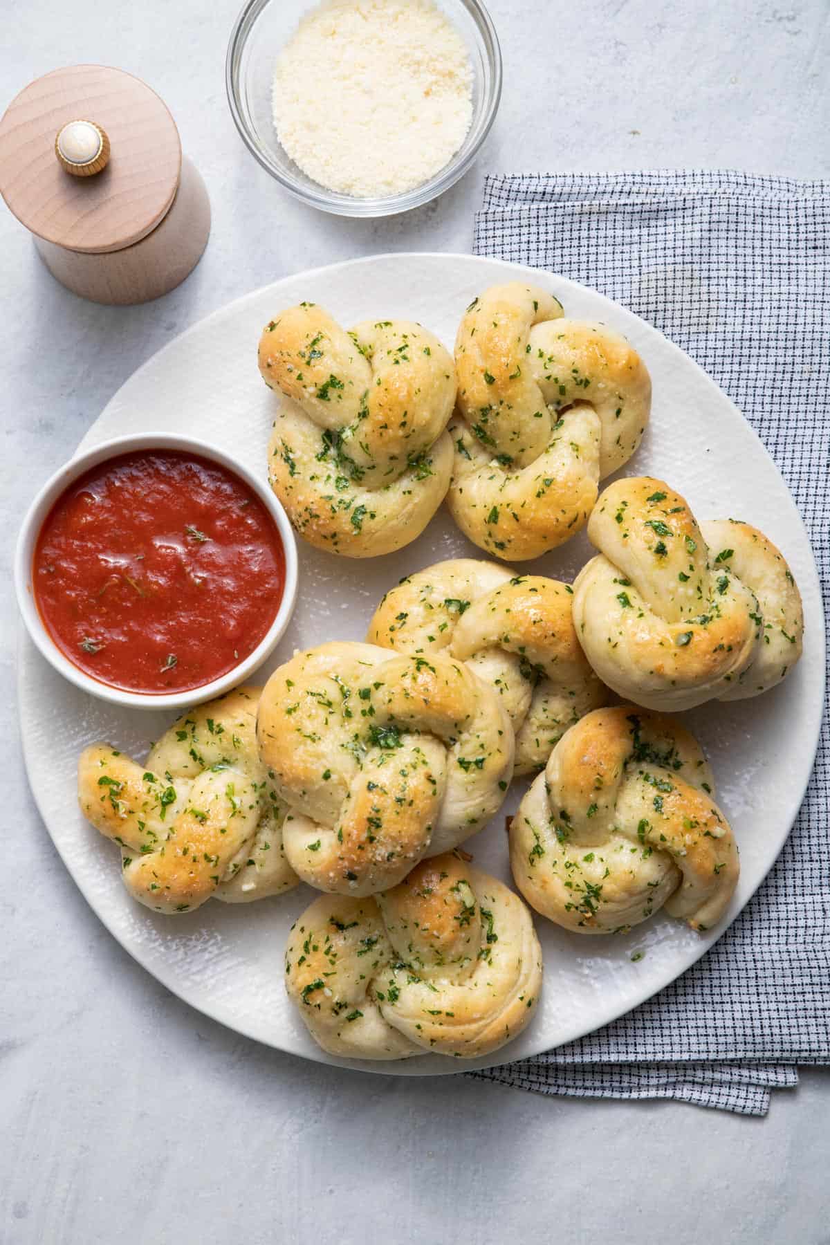 Garlic knots on a plate with marinara sauce