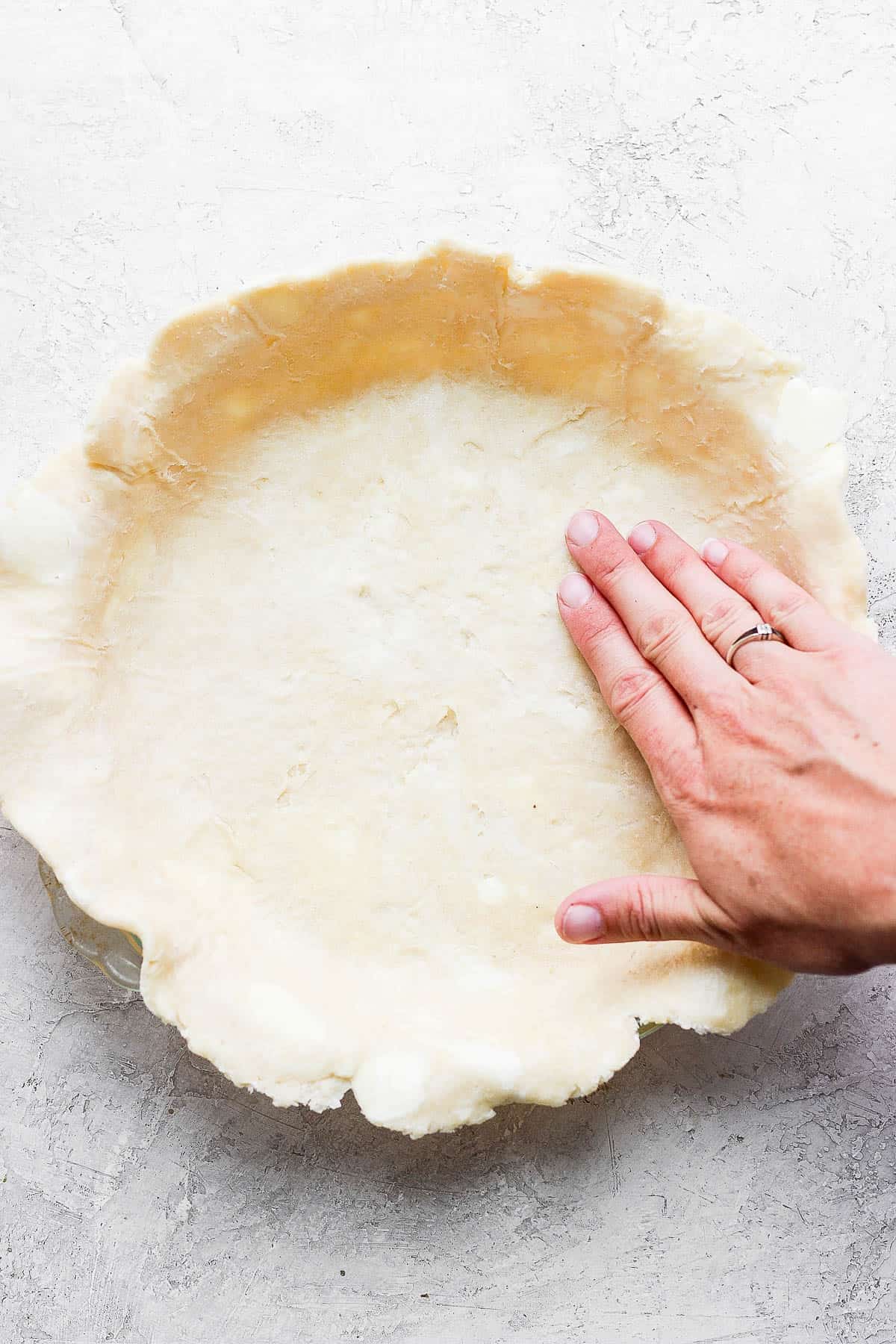 Forming pie crust around a pie dish