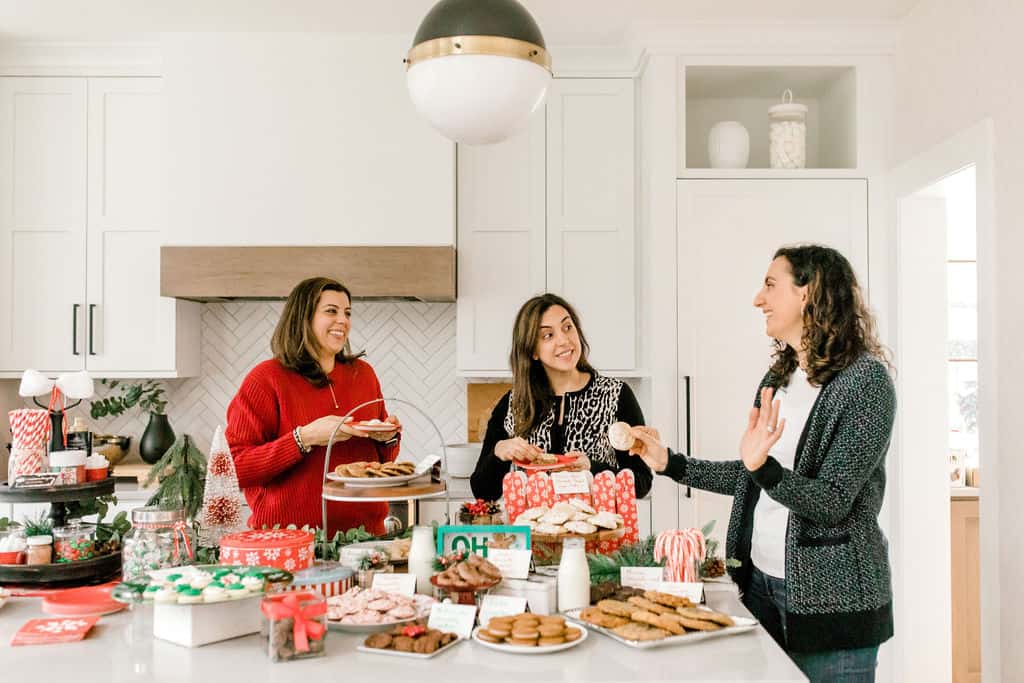 Yumna with sisters laughing at cookie exchange party