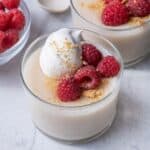 3 of the pudding cups topped with whipped cream, berries & crushed cookies.