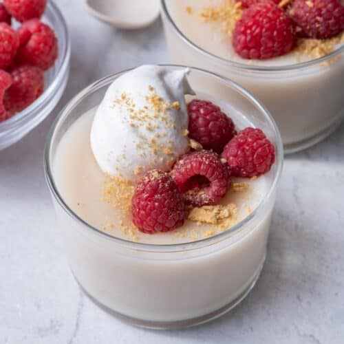 3 of the pudding cups topped with whipped cream, berries & crushed cookies.