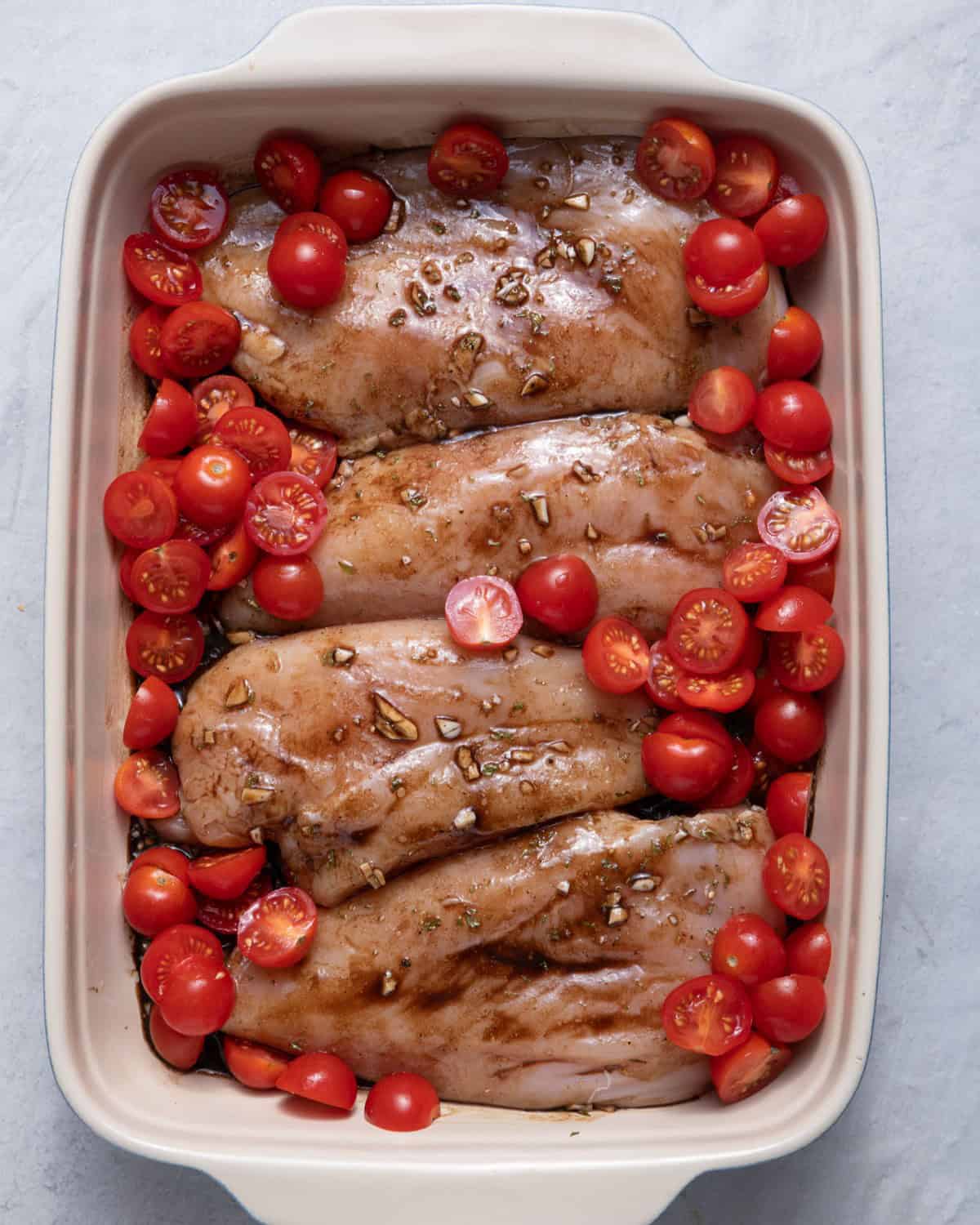 Tomatoes added around the chicken.