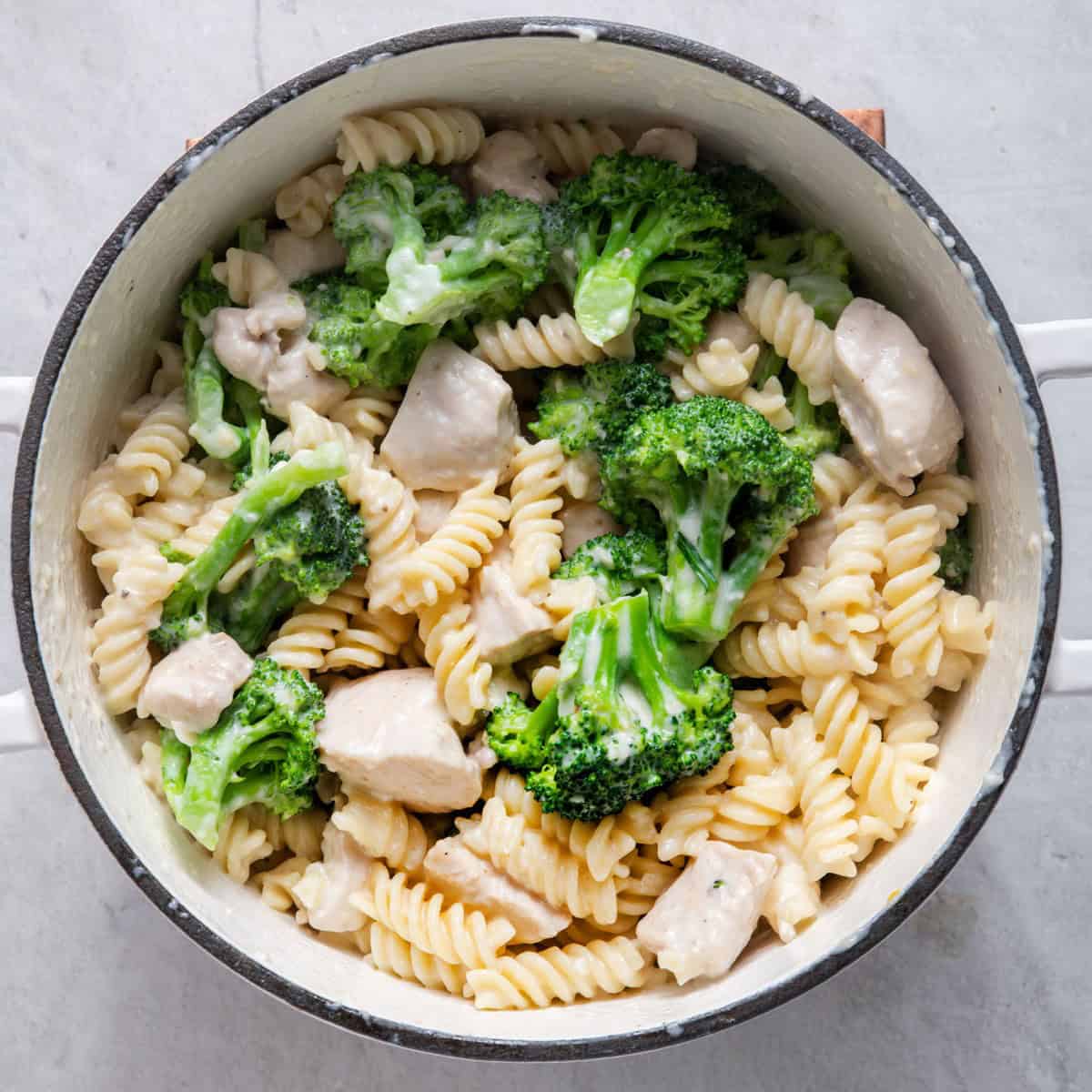 Alfredo sauce mixed in with the pasta, broccoli and chicken.