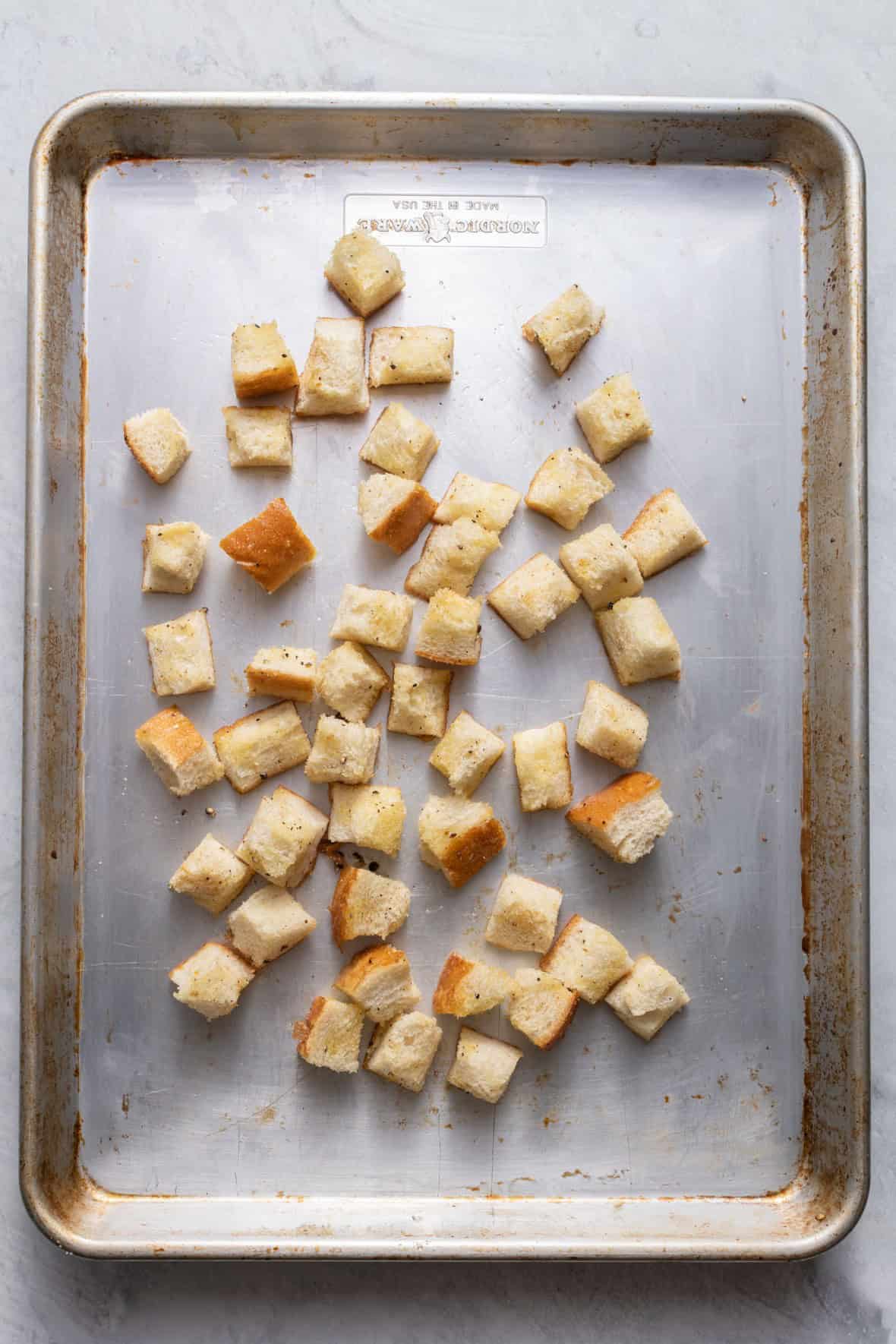 Croutons tossed in seasoning before baked.