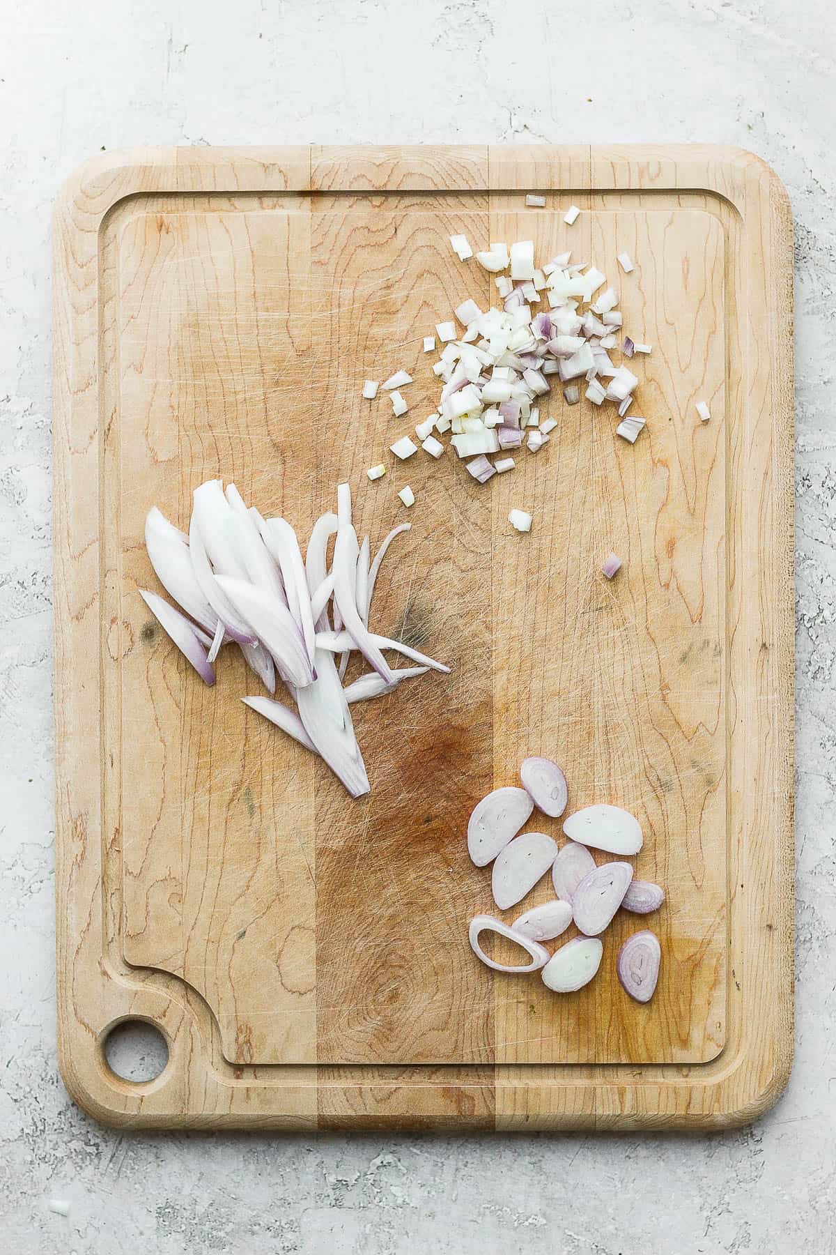 3 types of cuts for shallots on a cutting board