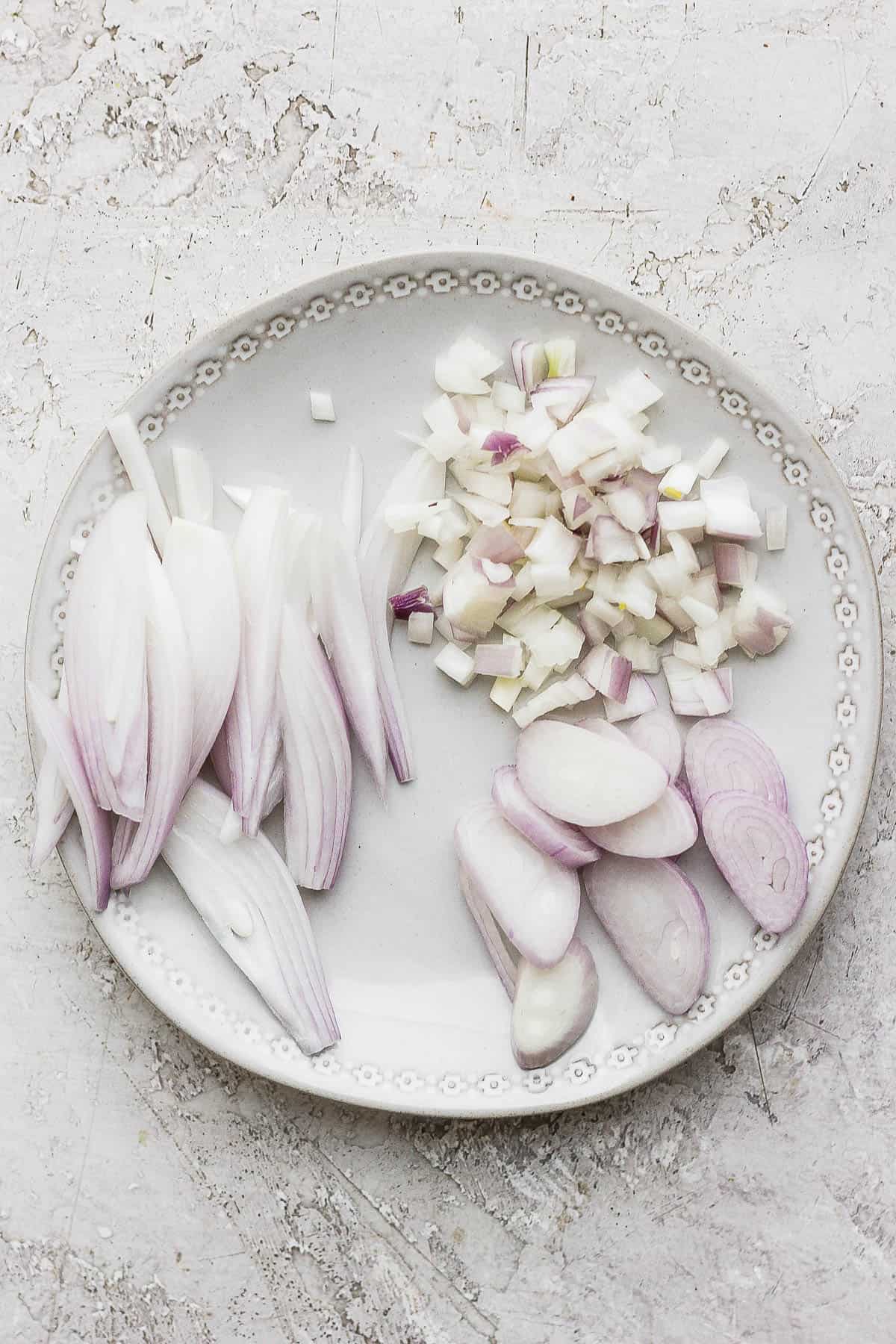 3 types of cuts for shallots on a white plate