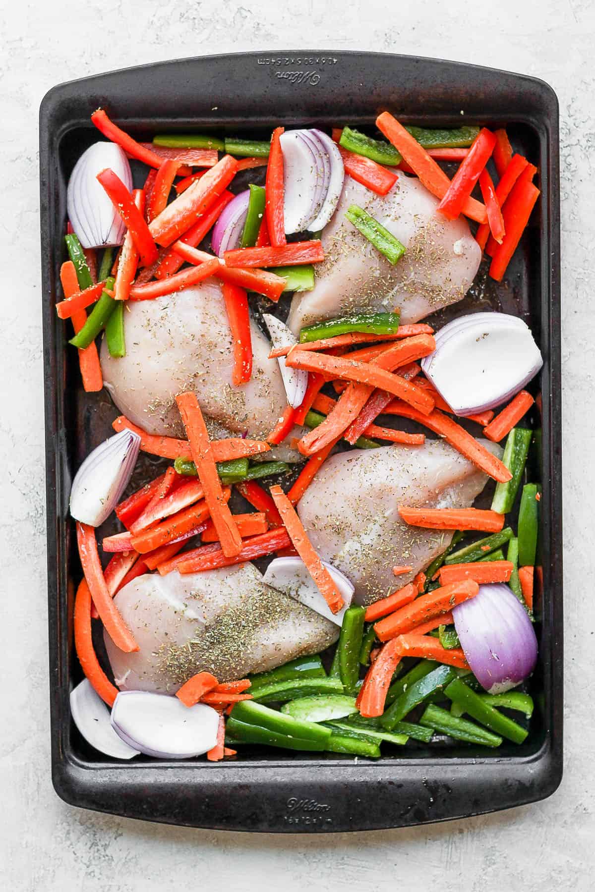 Sheet pan with ingredients before cooking
