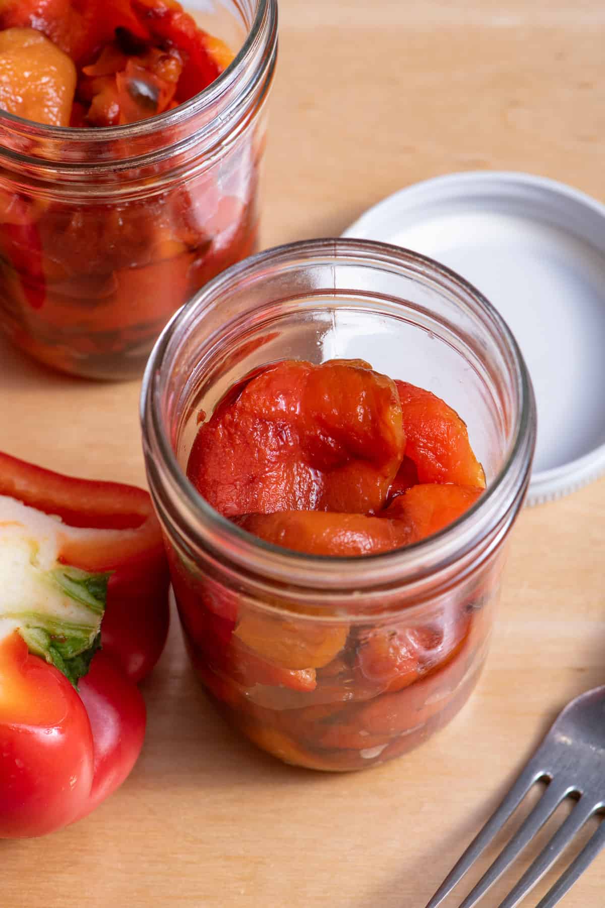 Roasted red bell peppers in glass jar