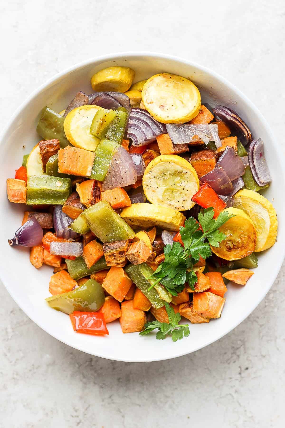 Roasted vegetables in a round bowl with parsley on top