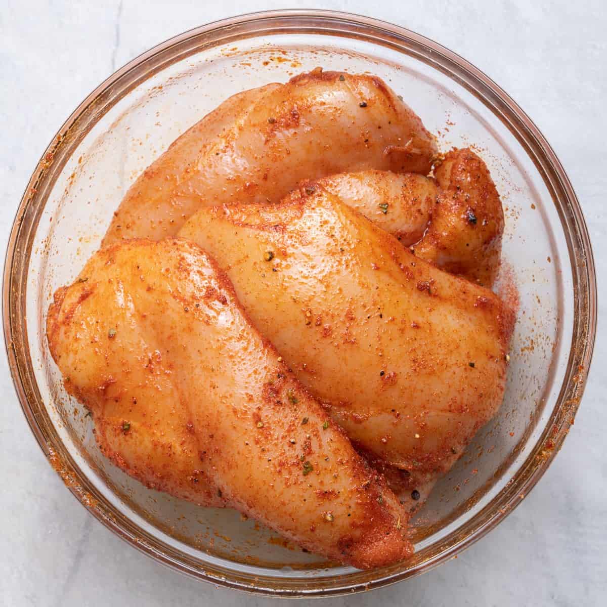 Seasoned chicken in a bowl.