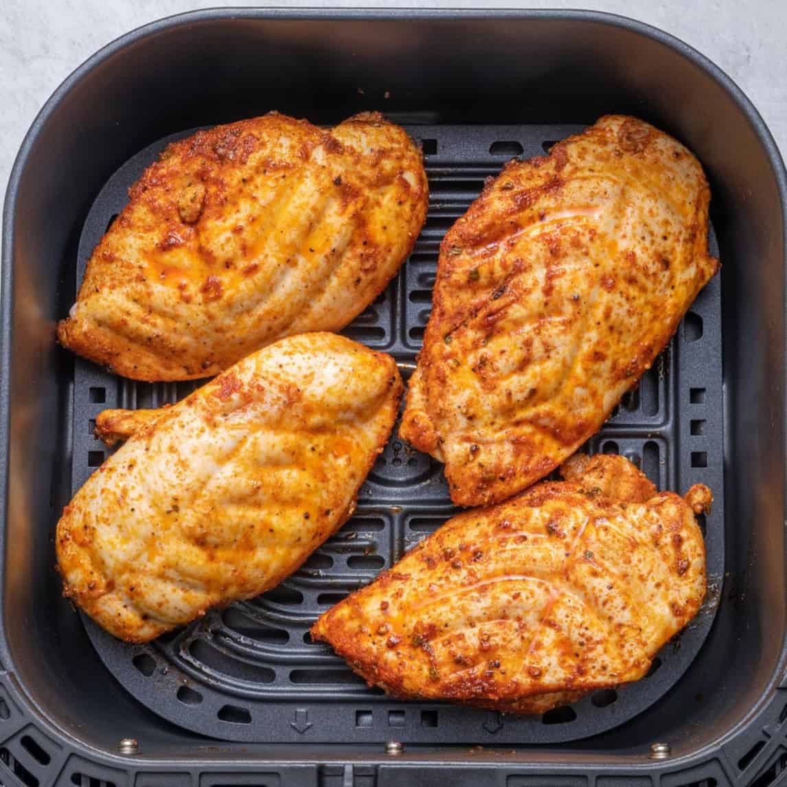 After cooking one side of the chicken and flipping.