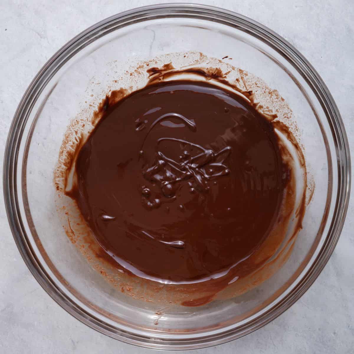 Melted butter and chocolate in a large bowl.