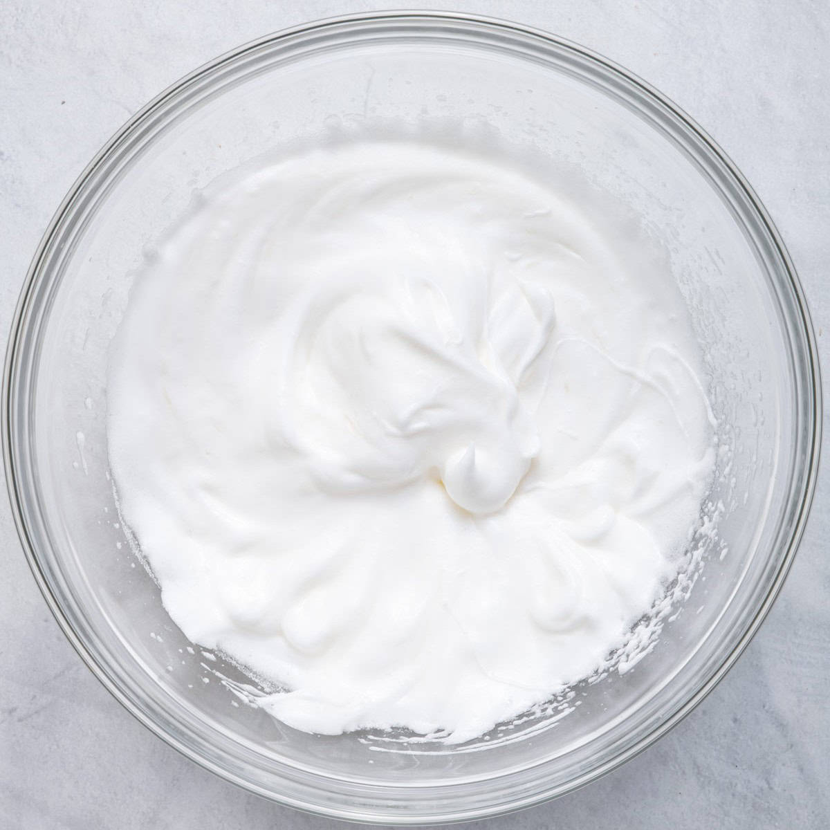 Stiff peak egg whites in another bowl.