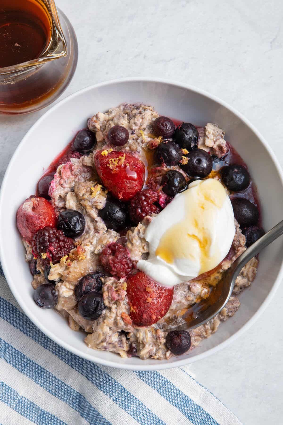 One pan baked oatmeal served in a bowl with greek yogurt and honey