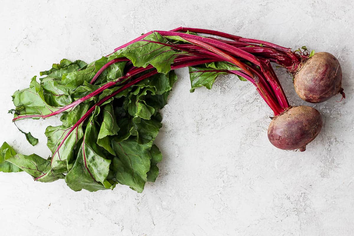 Fresh bunch of beets on white background
