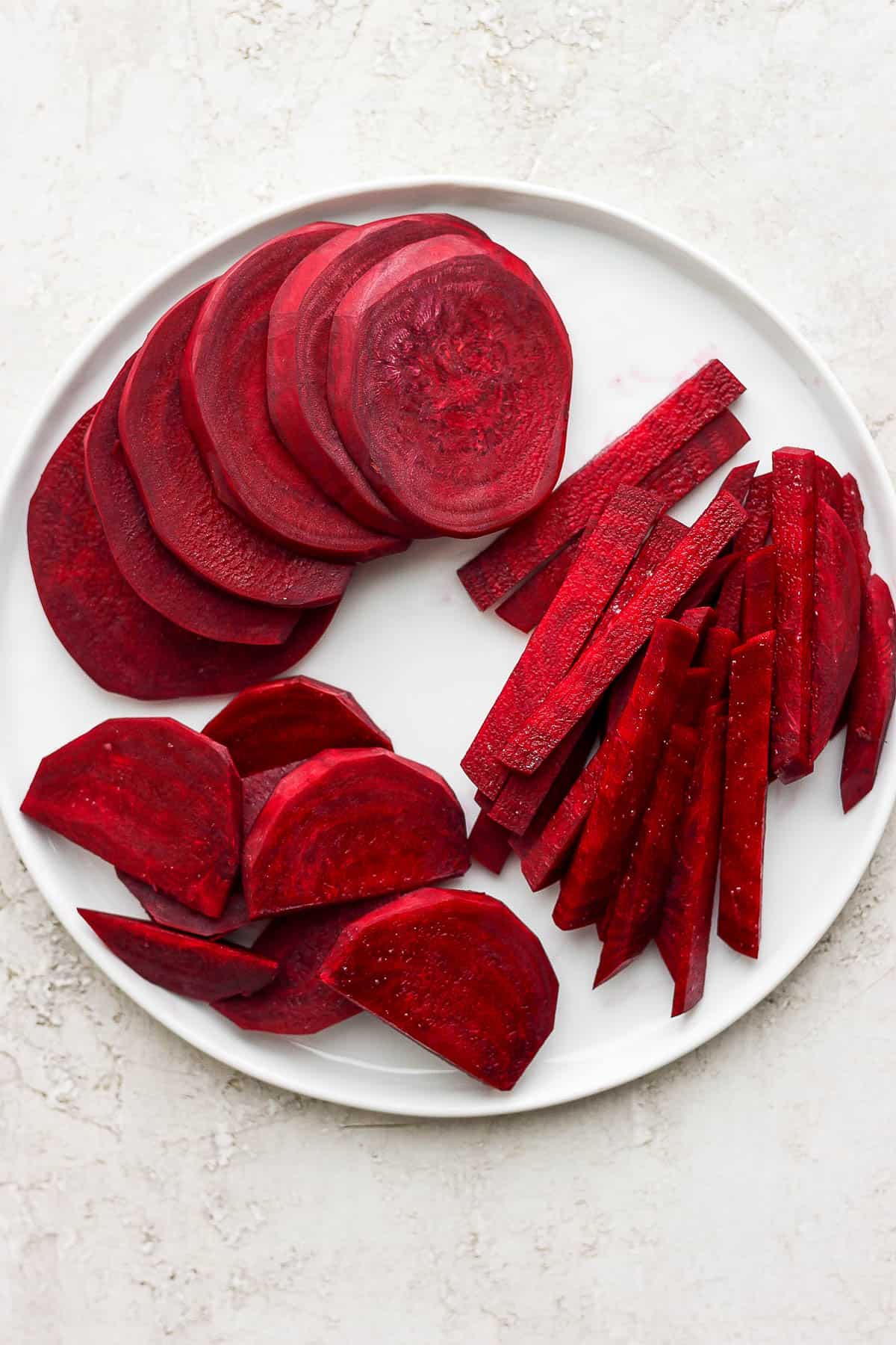 White plate with three types of cut beets