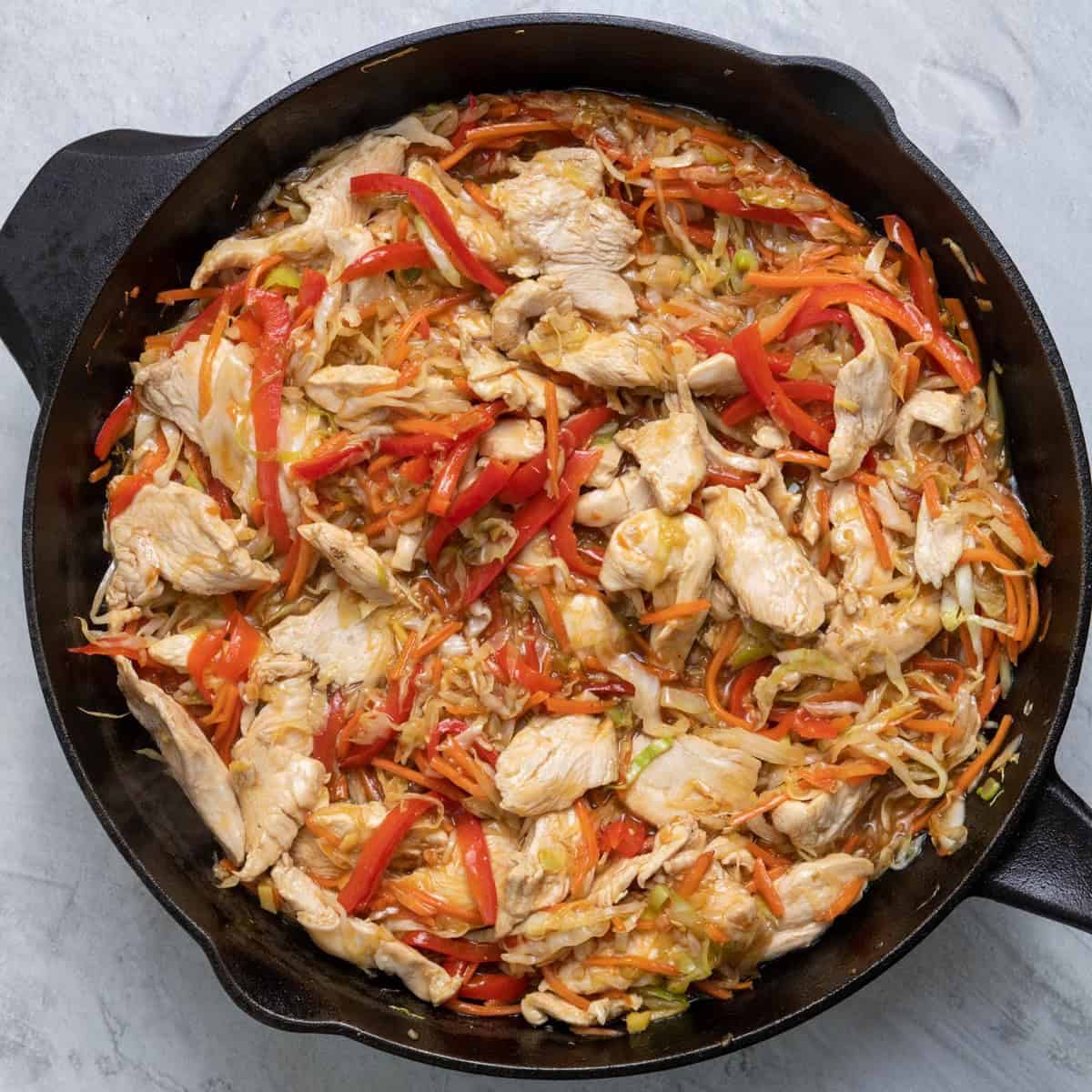 Sauce and chicken tossed with sauce thickened.