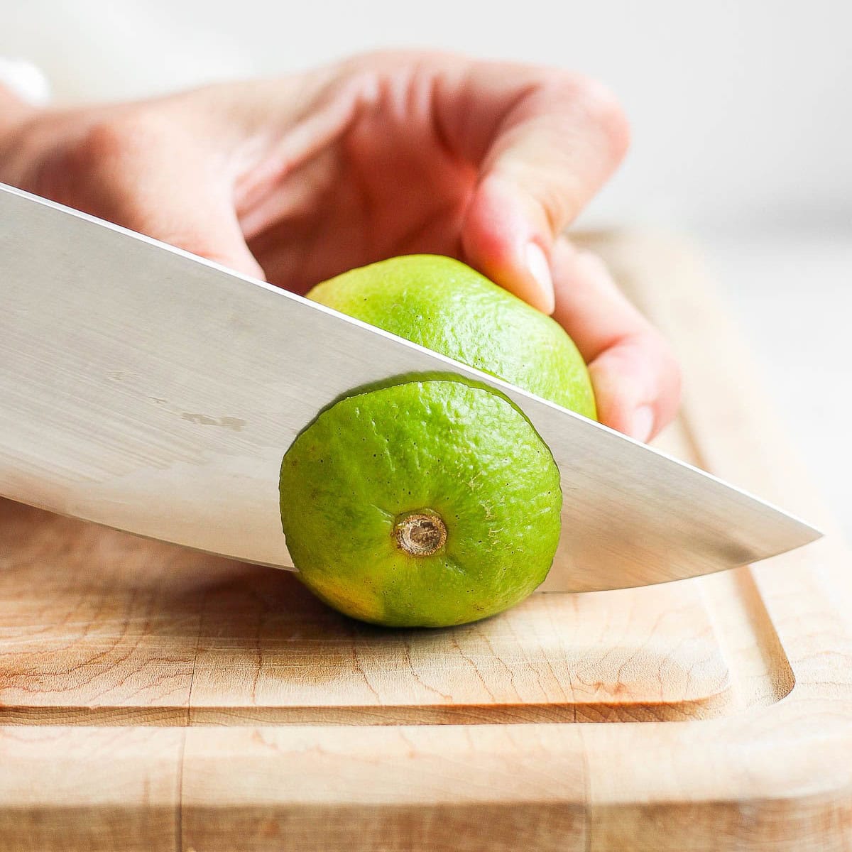 Slicing off inch from bottom of lime.