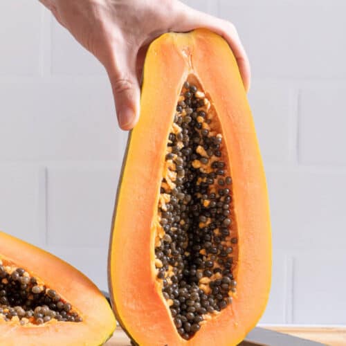 image showing inside of papaya after being cut in half lengthwise with seeds exposed