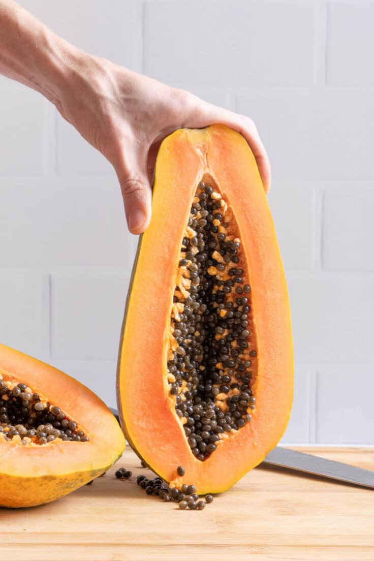 image showing inside of papaya after being cut in half lengthwise with seeds exposed