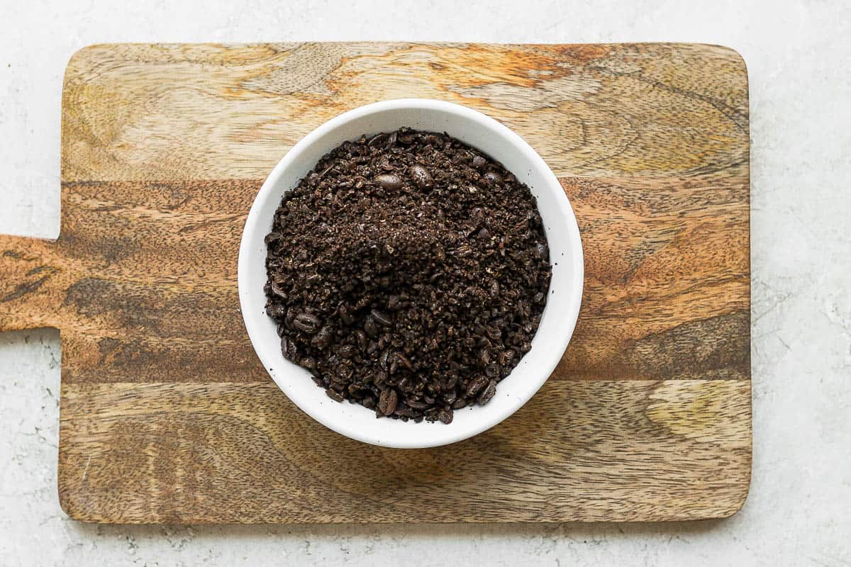 Bowl of coarse coffee sitting on cutting board