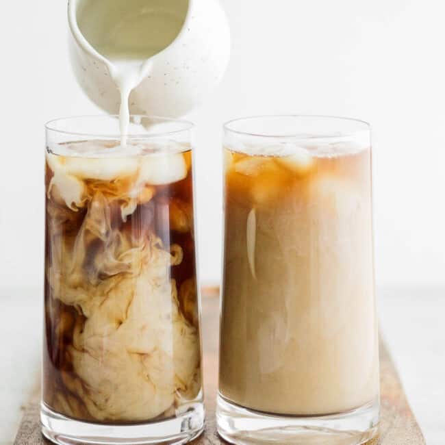 Pouring milk into cold brew over ice