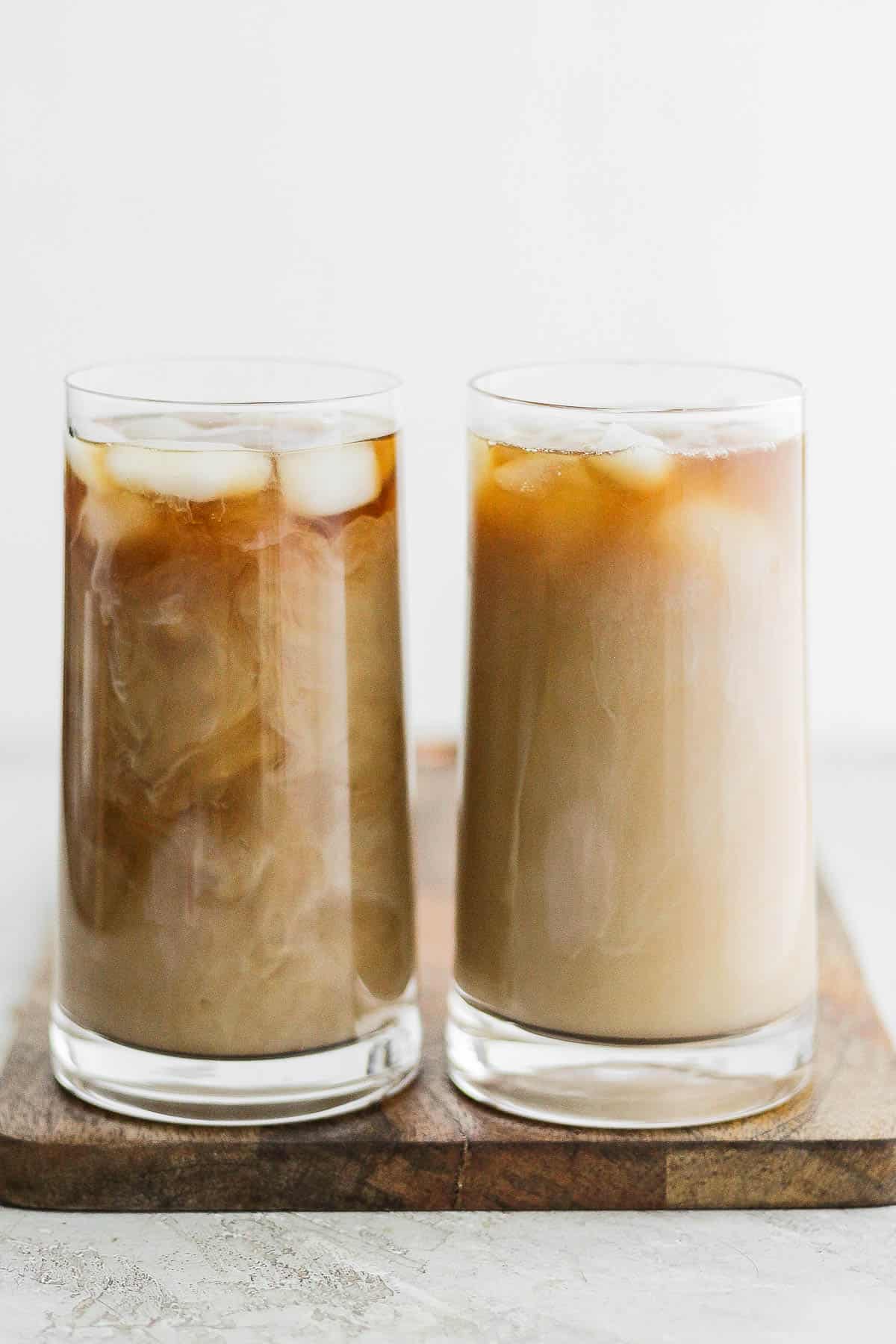 2 tall glasses of cold brew served over with milk