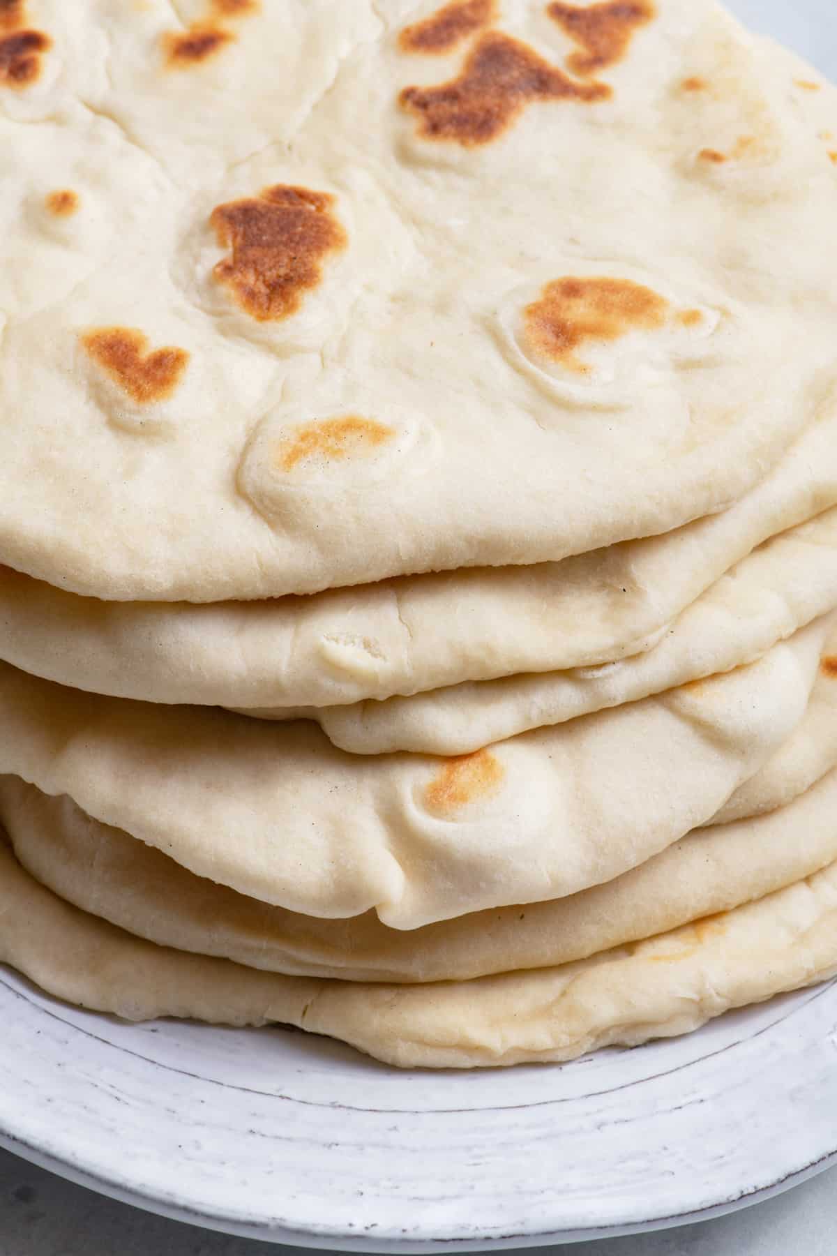 Close up shot of homemade flatbread on a white plate