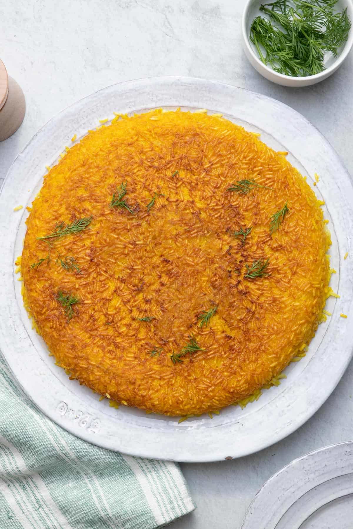 overhead shot of crispy Persian Tahdig Rice on white serving plate