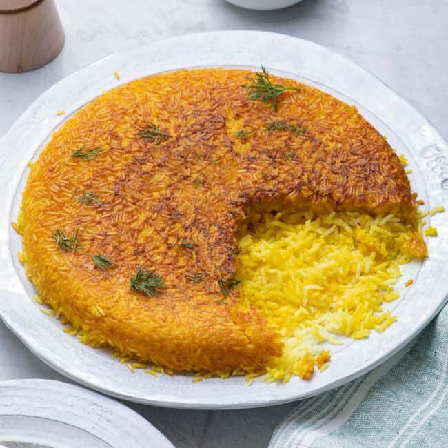 Serving plate with crispy Persian rice with a serving removed