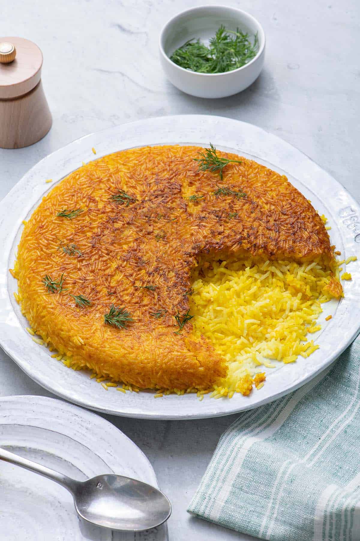 Serving plate with crispy Persian rice with a serving removed
