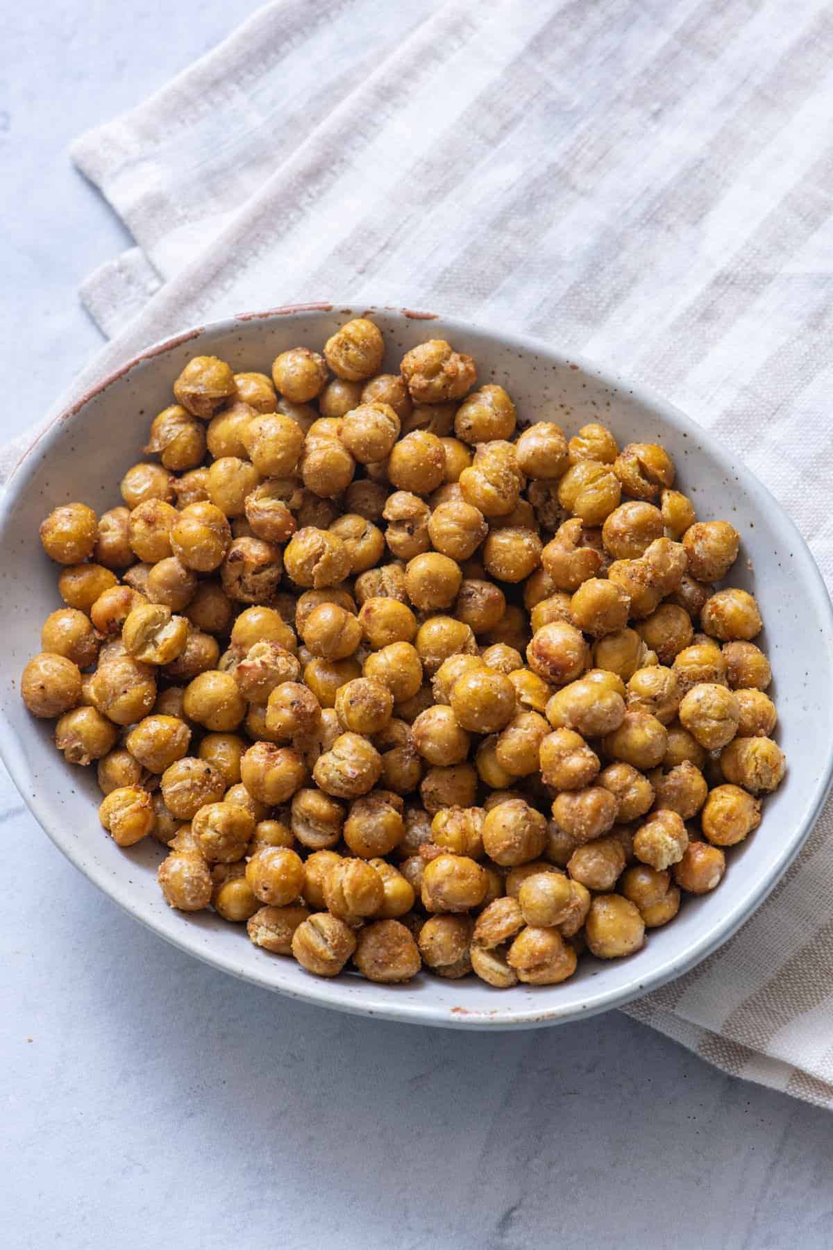 Overhead shot of crispy air fryer chickpeas in oval bowl.