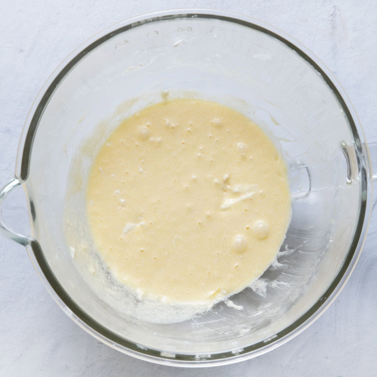 Eggs, milk and almond extract beat into the butter and sugar.
