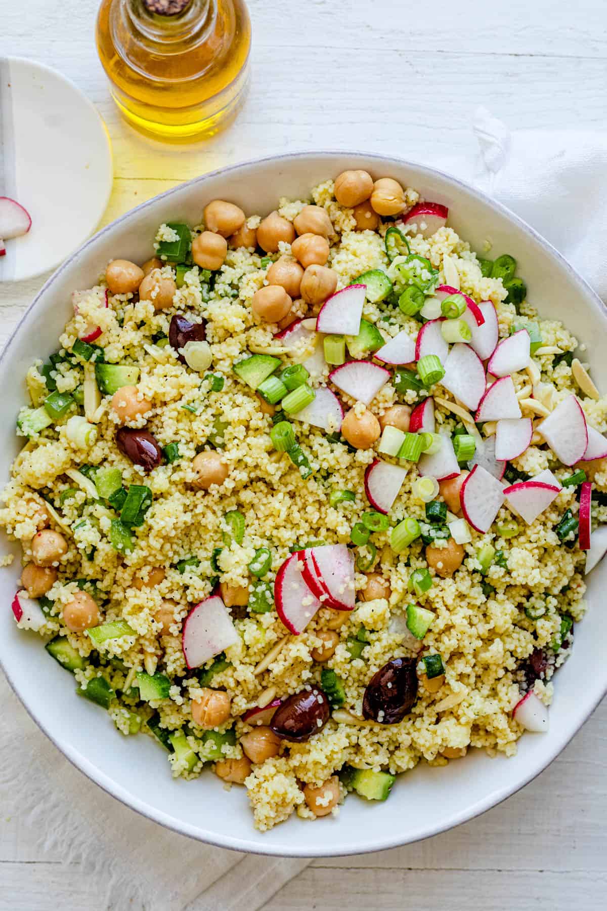 Large serving bowl with salad topped with fresh ingredients.