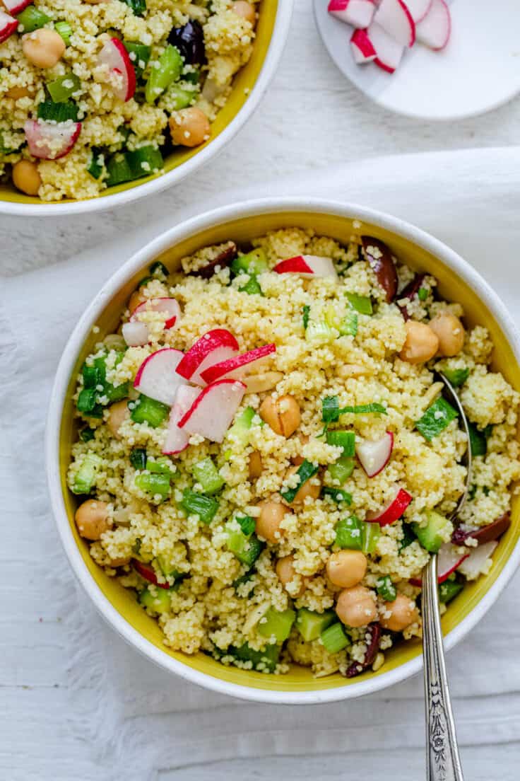 Overhead shot of Chickpeas Couscous Salad with spoon in bowl.