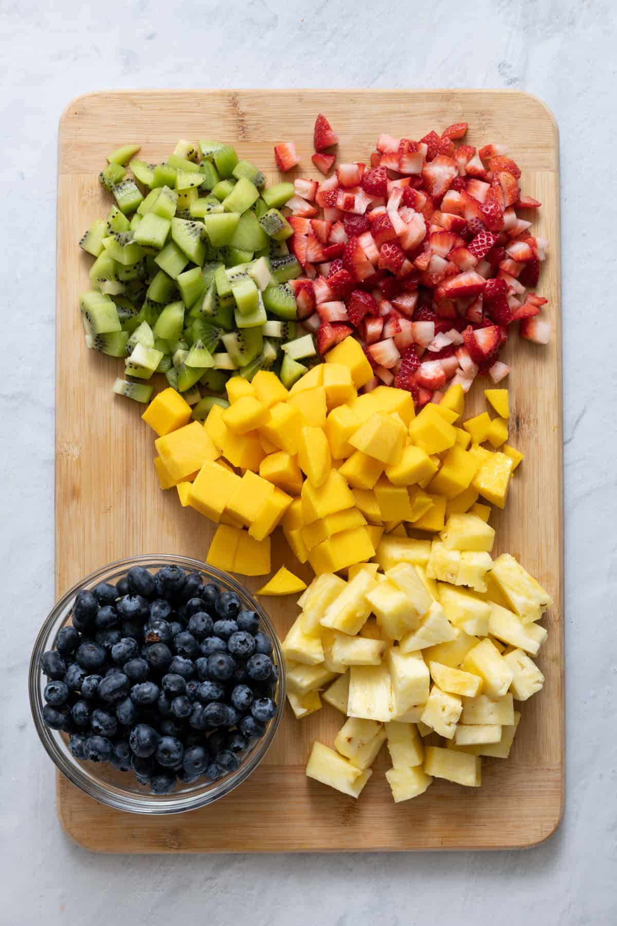 Cutting board with prepared cut fruit for recipe.