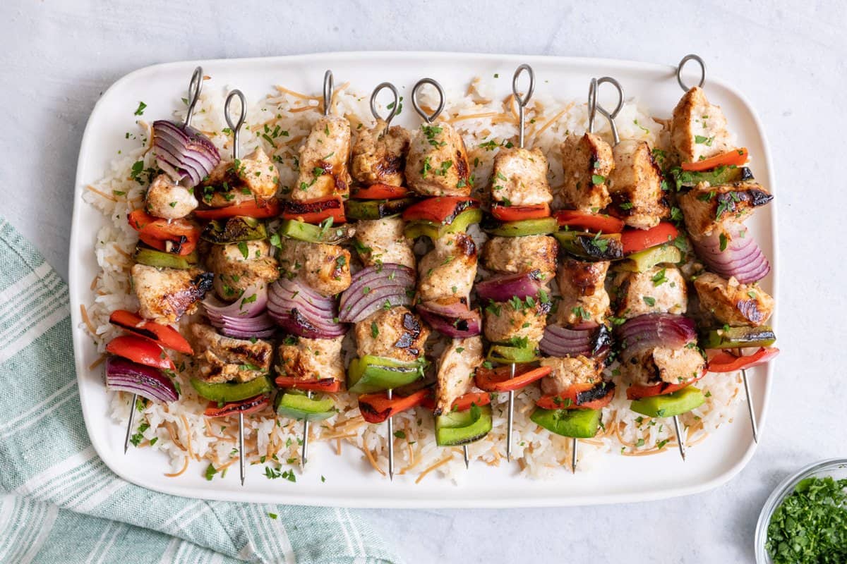 Large platter of grilled chicken kabobs served over Lebanese rice.