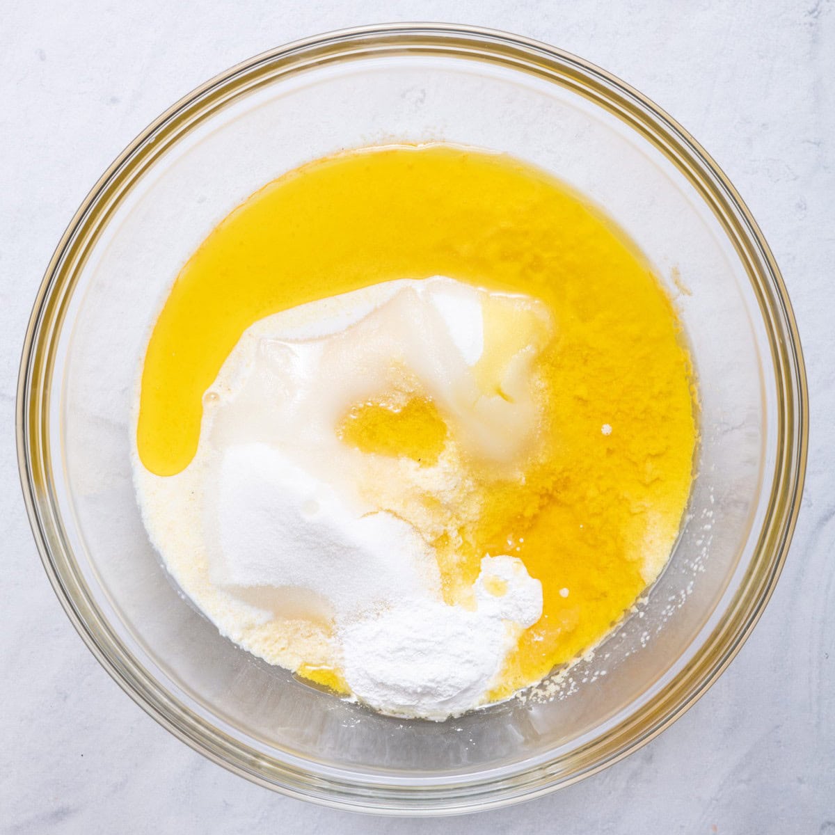 Semolina, sugar, ghee, milk and baking powder all in a bowl.